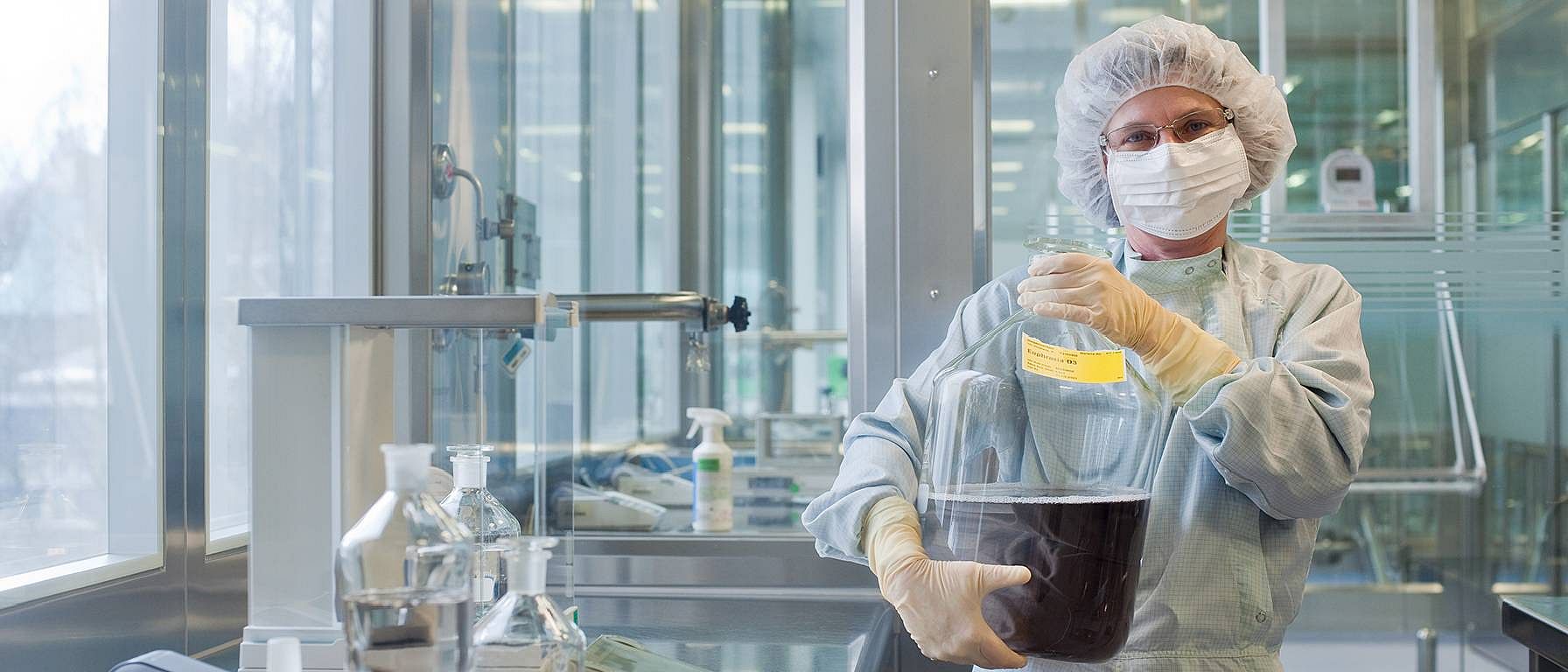 person in lab coat working in laboratory