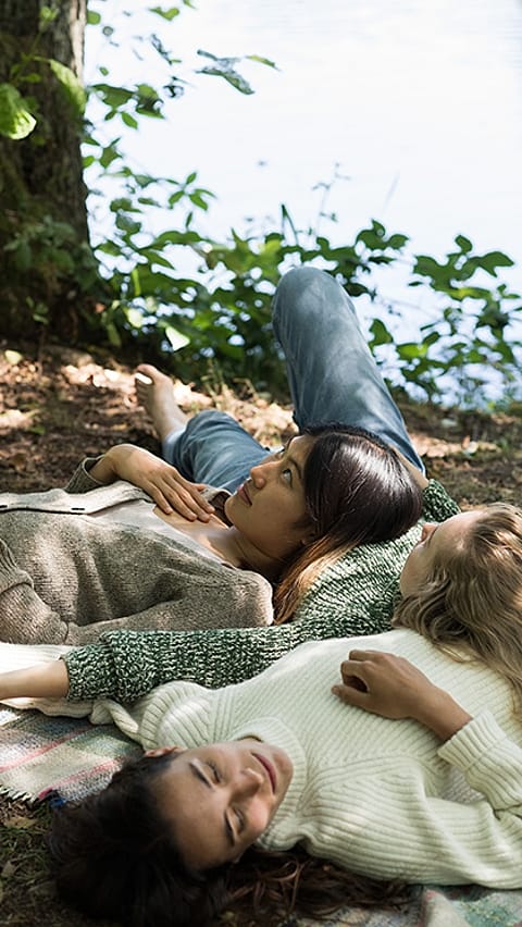 people laying in grass