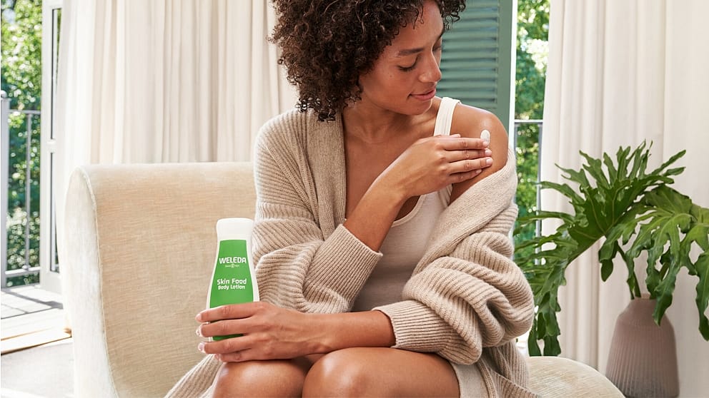 woman applying skin food body lotion