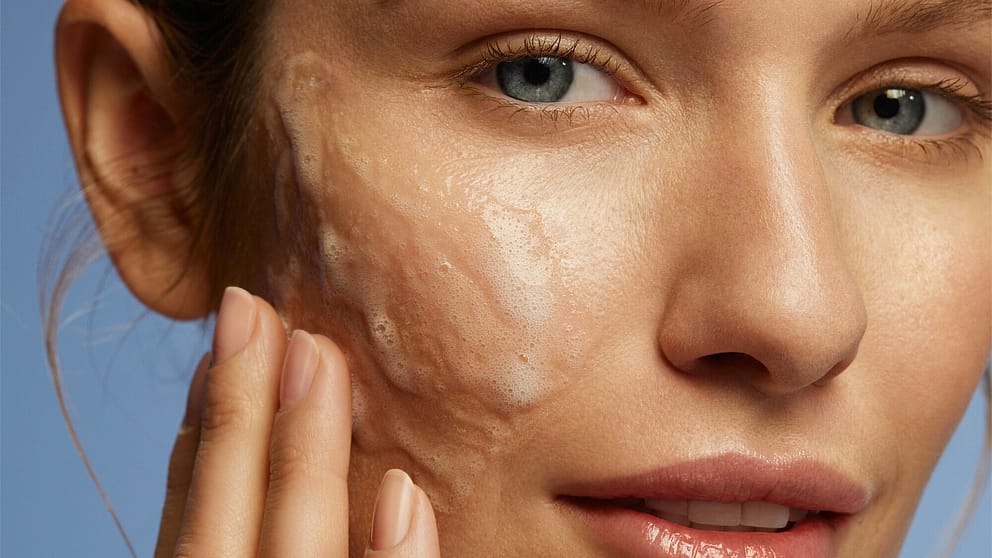 model applying deep cleansing gel to face