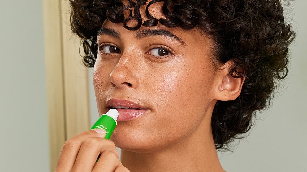 model applying skin food lip butter